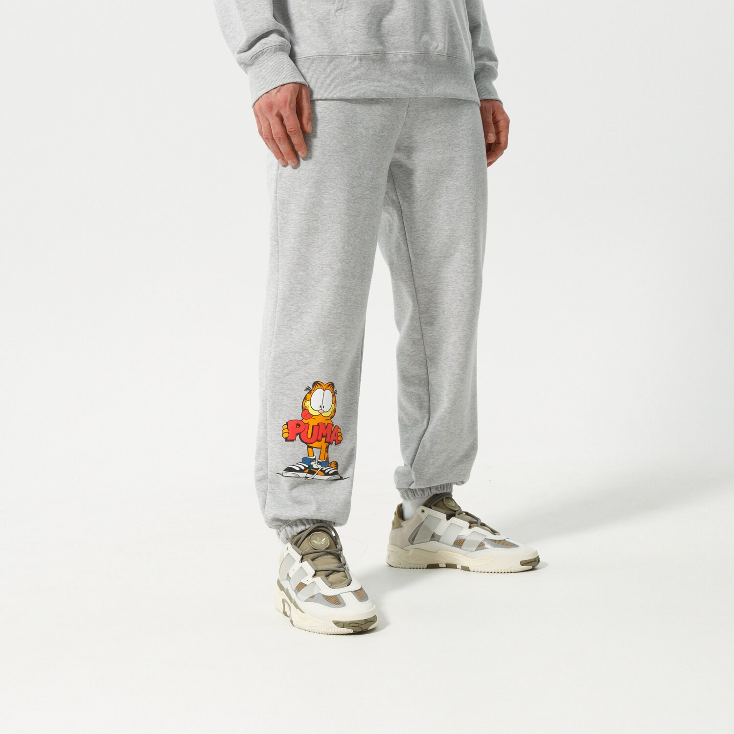 Bărbați pantaloni PUMA PANTALONI  PUMA X GARFIELD SWEATPANTS 534436 04 Gri