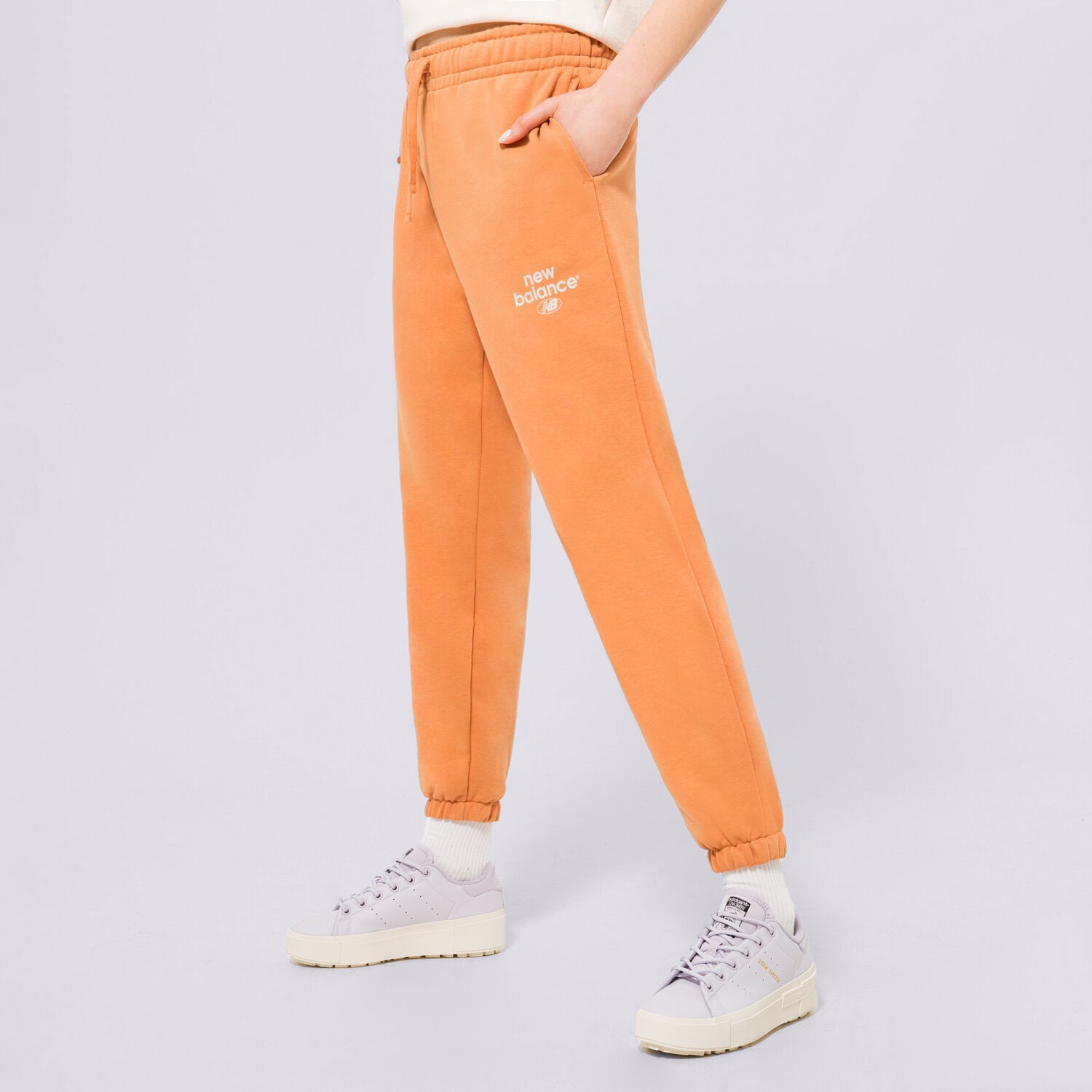 Femei pantaloni NEW BALANCE PANTALONI  NB ESSENTIALS GRAPHIC FLEEC WP31508SEI Portocaliu